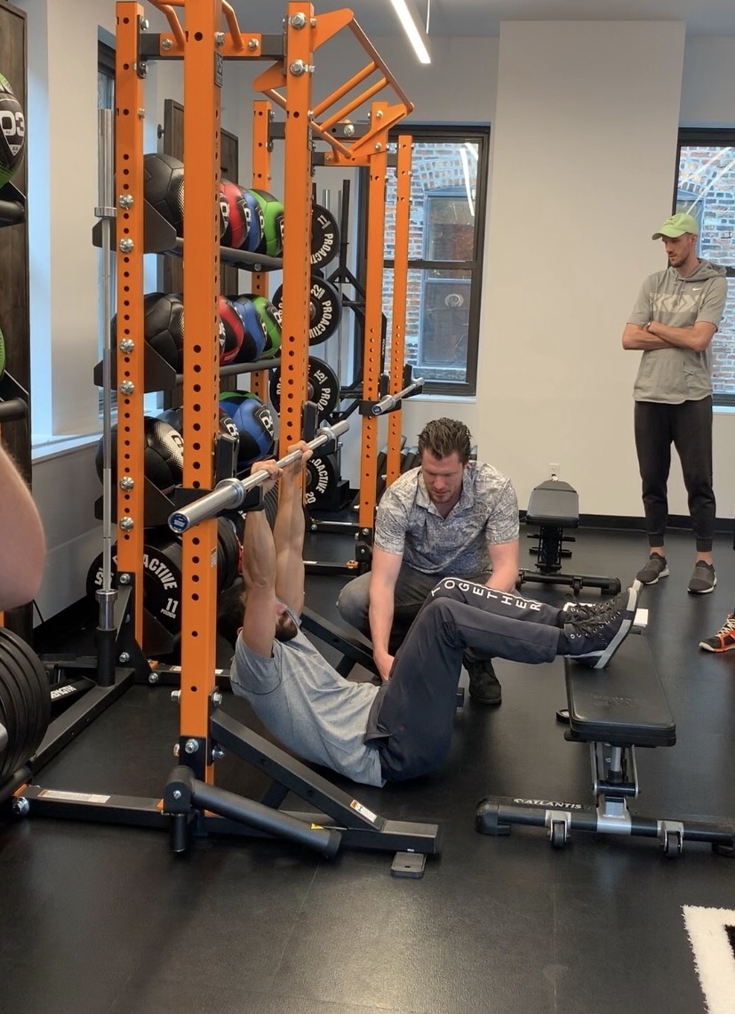 Coach cueing a loaded position inside the New York clinic